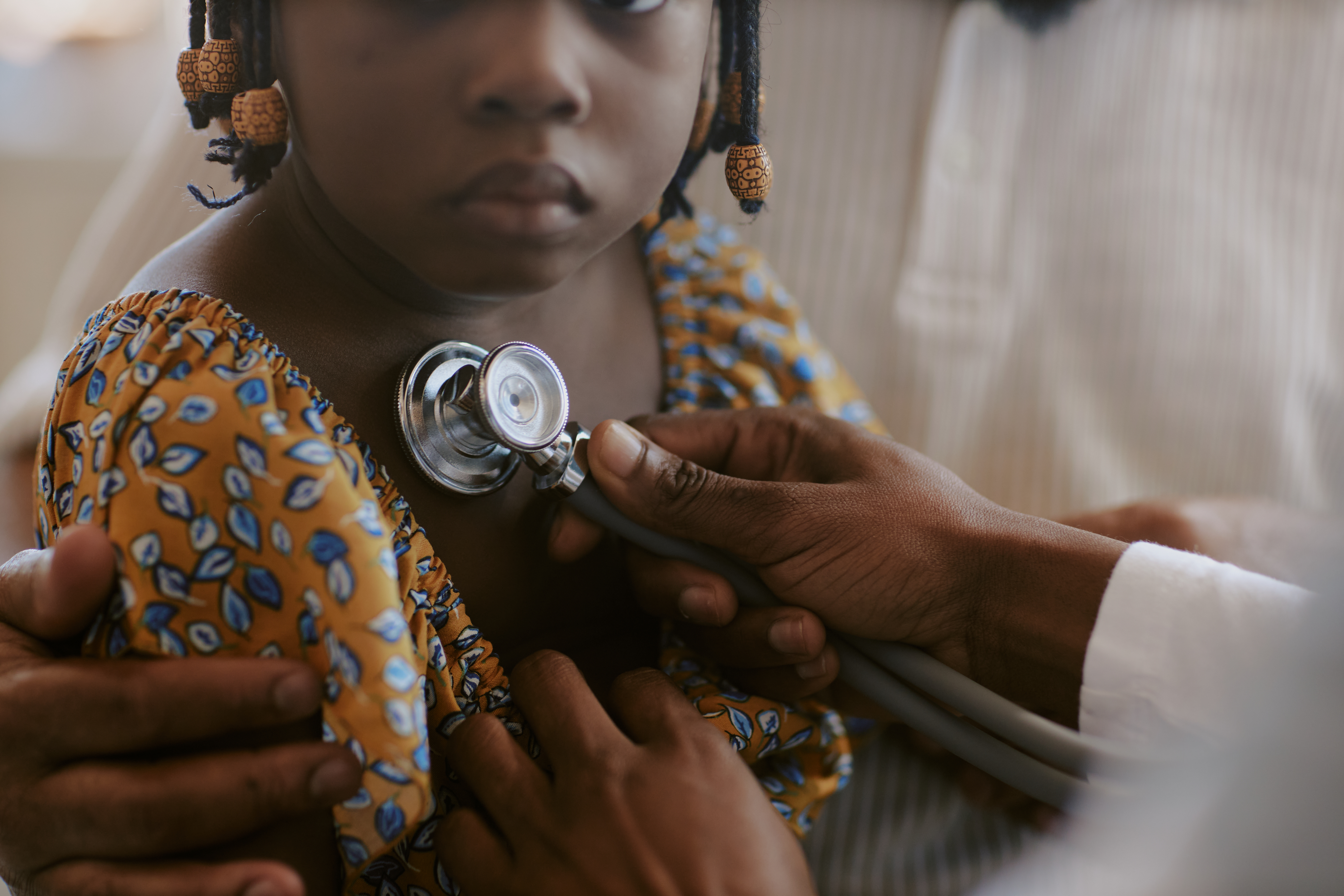 Portrait of child receiving medical examination with stethoscope, demonstrating healthcare procedures and medical care setting